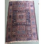 An Eastern blue ground rug, with geometric patterns,