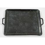 Manner of John Pearson, a copper two-handled tray, 50.