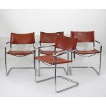 A set of four chrome tubular chairs with tan leather seats and backs