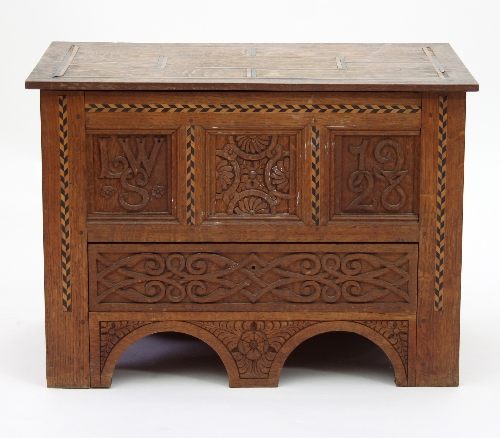 An Arts and Crafts oak mule chest of small proportions,