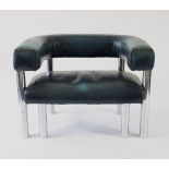 A leather upholstered tub style armchair with tubular chrome frame and stud detailing,