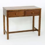 A Gordon Russell oak two-drawer desk on square legs with H stretcher, stamped 1954,