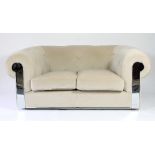 A pair of Fendi cream two-seater sofas, with button upholstery and chrome trim,