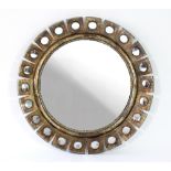 A large circular mirror, the bronzed frame set with small convex mirrors,