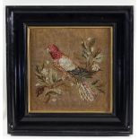 A Victorian woolwork picture of a parrot perched on a branch,