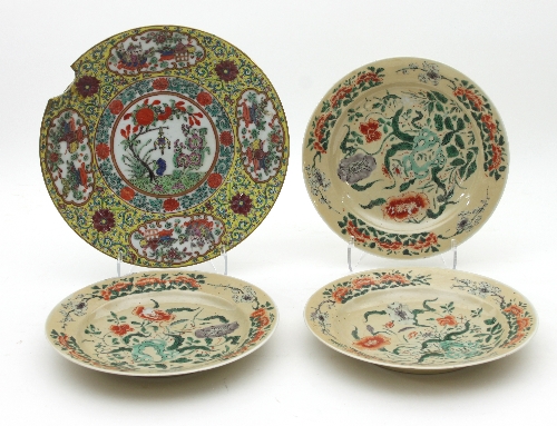 Three Chinese plates, Qianlong circa 1780, enamelled flowering plants to a caramel coloured ground,