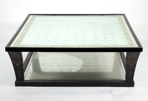 A large square modern coffee table with silvered and verre églomisé top on ebonised mirror panelled