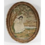 A Georgian oval silkwork picture of a young lady and her dog beneath a tree,