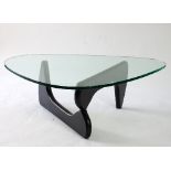 A Noguchi glass coffee table designed by Isamu Noguchi, on black lacquered base,