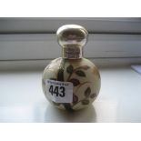 An early 20th century silver top scent bottle.