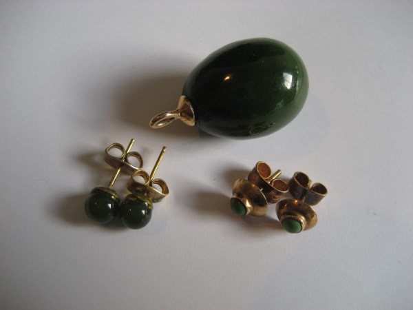 A pair of gold green stone earrings together with pair. A yellow metal green stone pendent. (