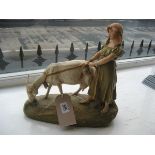 A Royal Dux figure of a young girl holding the rope of a grazing donkey, pink triangle mark to base,