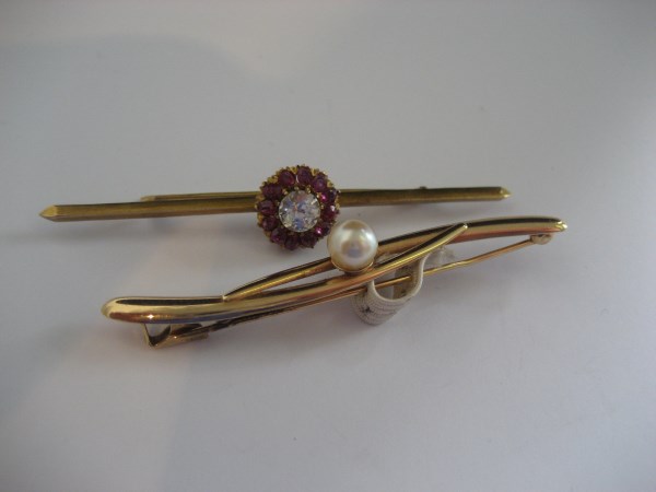 A 14ct gold bar brooch together with a yellow metal example (2).