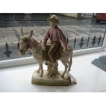 A Royal Dux figure, young boy on donkey, 1989, pink triangle to base. 38cm high.