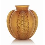 A Chardons Vase, No. 929
designed 1922, cased butterscotch
7 5/8 in. (19.4 cm.) high
moulded R.