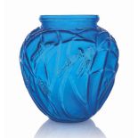 A Sauterelles Vase, No. 888
designed 1912, electric blue and white stained
11 ¼ in. (28.7 cm.)