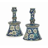 A PAIR OF POTTERY CANDLESTICKS IN THE IZNIK 'DAMASCUS' STYLE ULISSE CANTAGALLI, FLORENCE, ITALY,