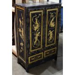 Chinese gilt black lacquered cabinet, fronted by double doors carved with apsara and sides with