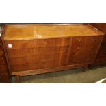 Mid-Century Modern style dresser, having a rectangular top above the eight drawer case, and rising