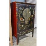 Chinese polychrome black lacquered cabinet, with a pair of hinged double doors painted with children