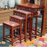 Set of four Chinese nesting tables, each inset with a burlwood floating panel, the apron pierced