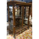 Arts and Crafts oak display cabinet, having a rectangular top, above the two door case, flanked with