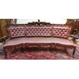 Victorian style large mahogany settee, having an figural crest depicting an eagle, above the