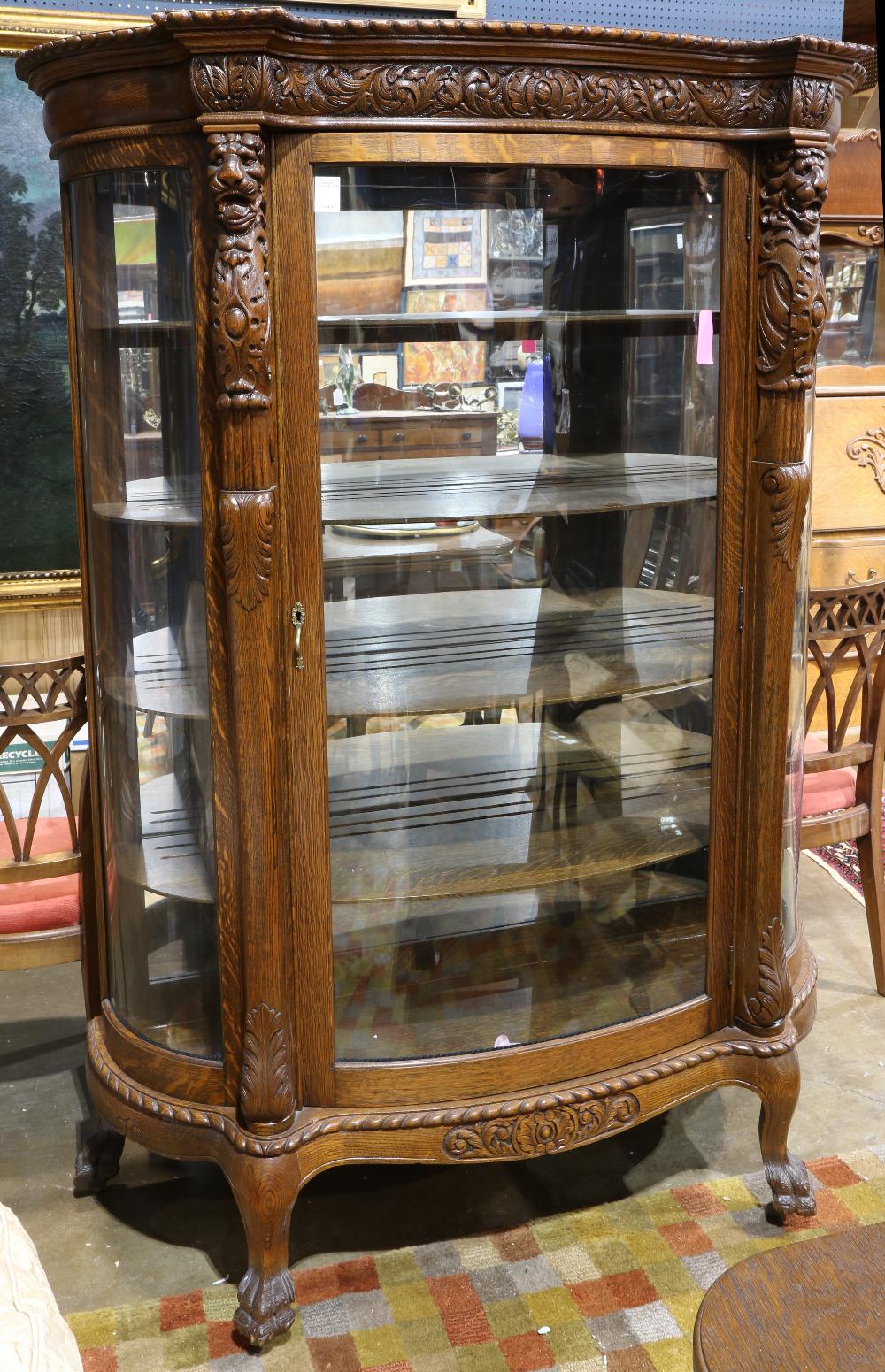 American Victorian oak display case, having a molded top with a gadrooned border, above the case