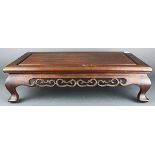 (Lot of 2) Chinese wooden low table, the apron pierced with tendril, raised on low supports;