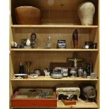 Six shelves of decorative art, including a manekin head, a Louix XV style gout stool, a miniature