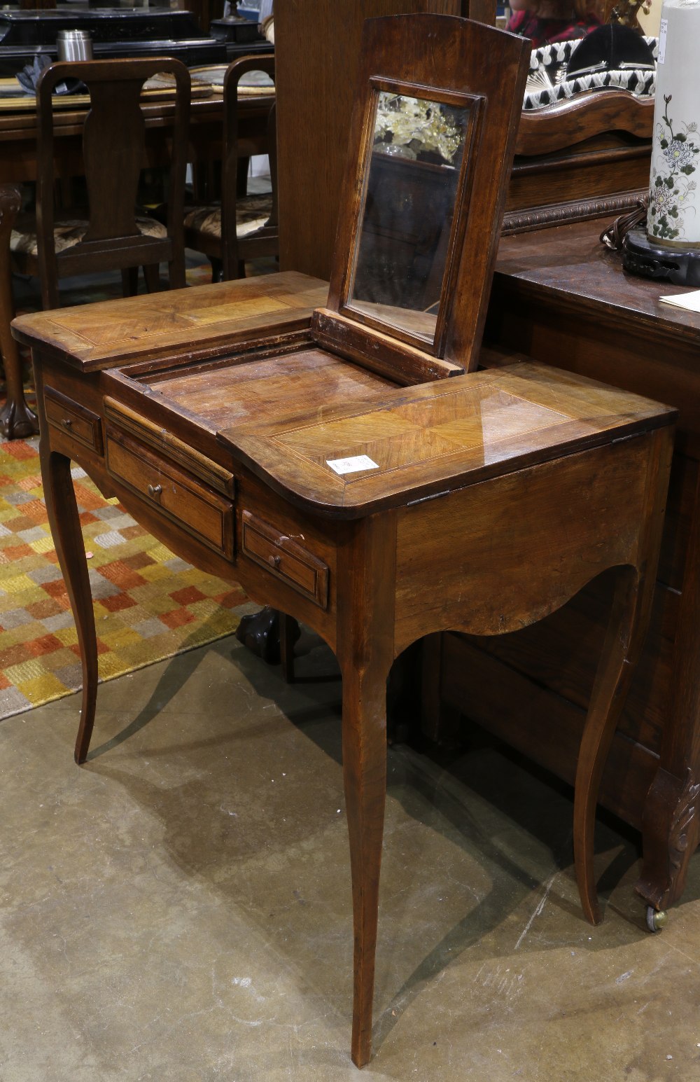 French Provincial style inlaid poudreuse, having a hinged shaped top, opening to reveal a mirror,