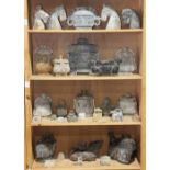 (lot of approximately 31) Four shelves of Chinese archaistic hardstone items, including vessels,