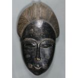 Baule, Cote d’Ivoire mask, having an elaborate coiffure, with stylized facial features and