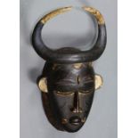 Lagoons region, Ghana mask with thin round horns, above stylized facial features, traces of blue and