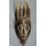 Baule, Cote d'Ivoire, mask, strong carving, four horns atop and small openwork beard below,