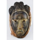 Baule, Cote d’Ivoire mask, having monochrome pigment decoration, with an elaborate coiffure,