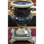 Empire style black marble baluster form vase with dolphin brass mounts, rising on a square base with