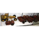 (Lot of 8) Group of cast iron and metal toys, including (4) trucks, (4) trailers, and a tractor,