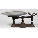 Antique scale with weights, having a cast iron polychrome base and tin tray, 10"h x 22"w x 11"d