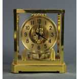 Jaeger Le Coultre Atmos clock, having a brass with glass paneled case, the circular dial with Arabic