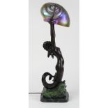 Tiffany style bronze figural lamp, having an iridescent aurene glass nautilus form shade,