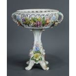 Dresden floral encrusted porcelain basket, having a pierced bowl, above a gilt accented footed base,