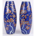 Pair of Chinese porcelain vases, with red enameled prunus on an underglazed blue ice-crackle ground,
