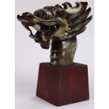 Chinese hardstone dragon head, the two horned mythical beast with jaws wide open, on wood stand,