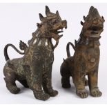 Pair of Southeast Asian metal lions, each seated on its haunches, accented with glass inlay, 13.75"