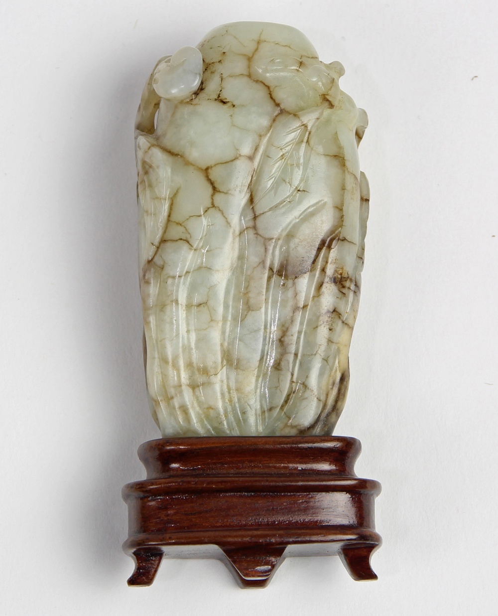 Chinese jade snuff bottle, of melon form accented by leafy tendrils carved in relief, the white-gray