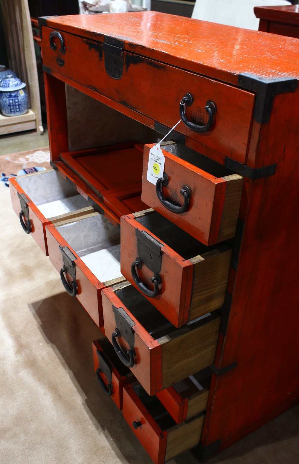 Japanese vermilion lacquered tansu, iron pole hangers on either end, a center drawer above three - Image 2 of 4