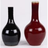 (lot of 2) Chinese small stick neck porcelain vases, the first of a black glaze thinning to brown at