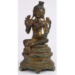 Chinese gilt bronze bodhisattva, seated in royal ease on a lotus pedestal, holding two lotus sprigs,