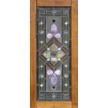 Victorian style stained glass window panel having a multicolor floral and geometric design